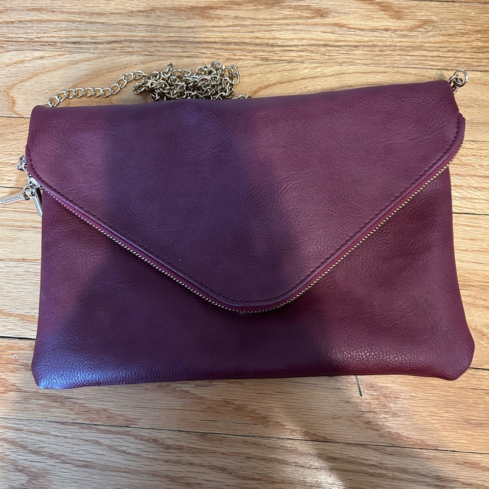 Red handbag converts to a clutch